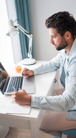 User browsing eRevival FAQ section on laptop for electronics recycling and secure data disposal information